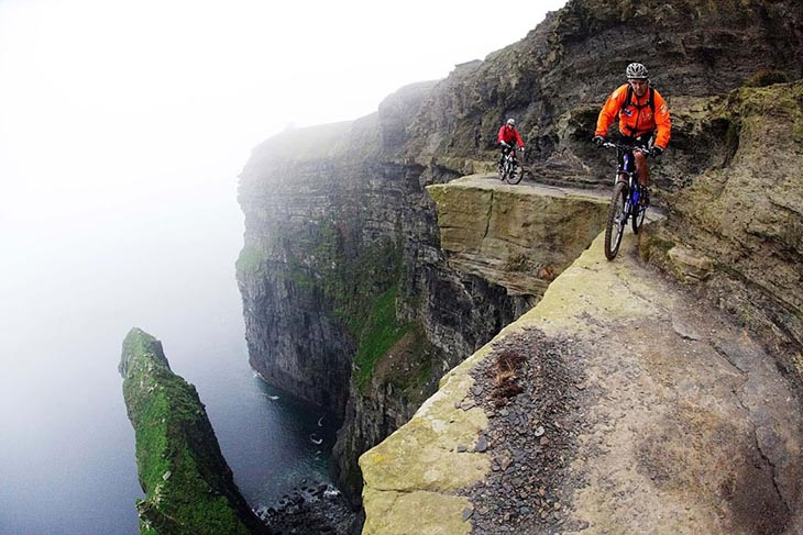 Hans Rey and Steve Peat riding bikes on mountain