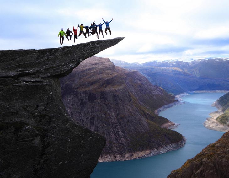 Jumping on the Trolltunga rock in Norway