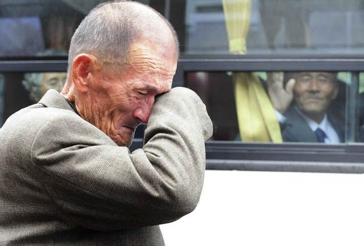 A North Korean waves at his South Korean brother after inter-Korean temporary family reunions.