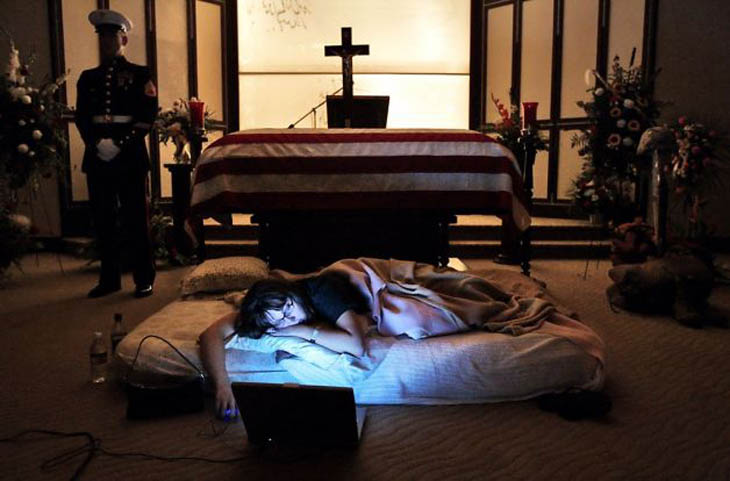 Wife of a fallen Marine, sleeps by his casket the night before his burial