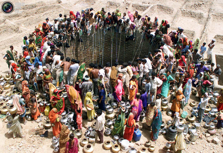 People gather water from a huge well in the village of Natwarghad in the western Indian state of Gujarat.