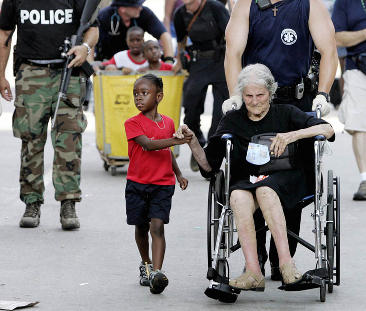 Tanisha Blevin, 5, holds the hand of fellow Hurricane Katrina victim Nita LaGarde, 105