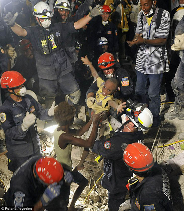 21st century photos - Kiki, age 7, is pulled from the ruins left by the Haiti earthquake