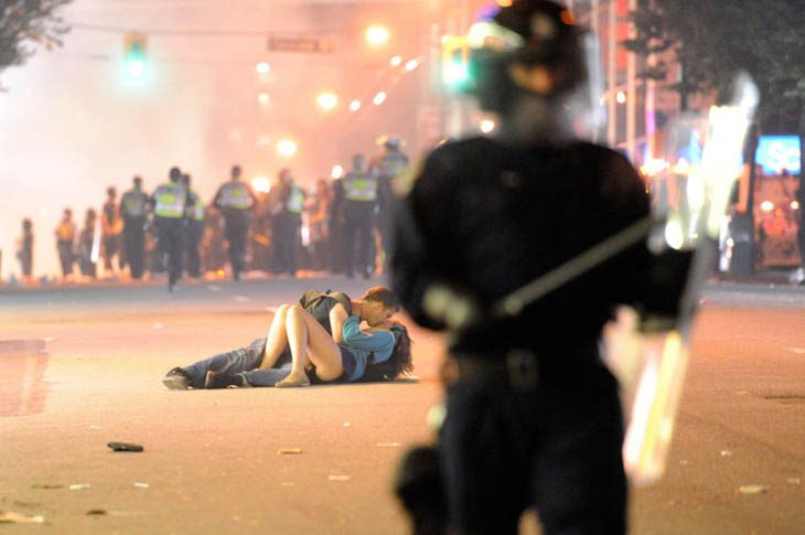 21st century photos - A couple kisses on the pavement during the Vancouver Riot [2011]