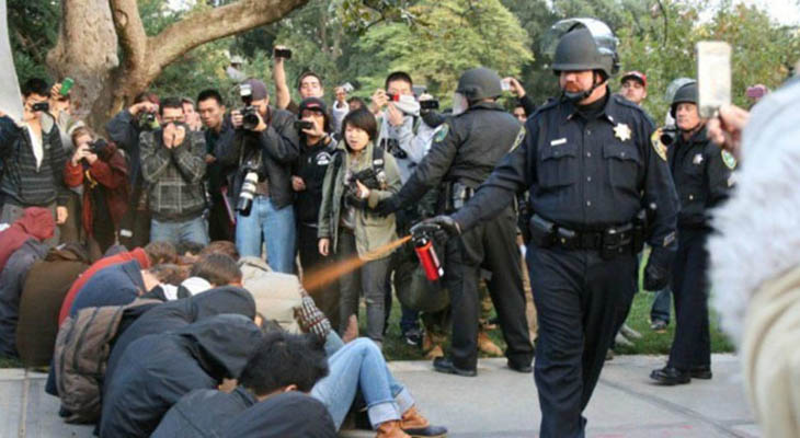 21st century photos - A police officer pepper-sprays Occupy protesters at the University of California