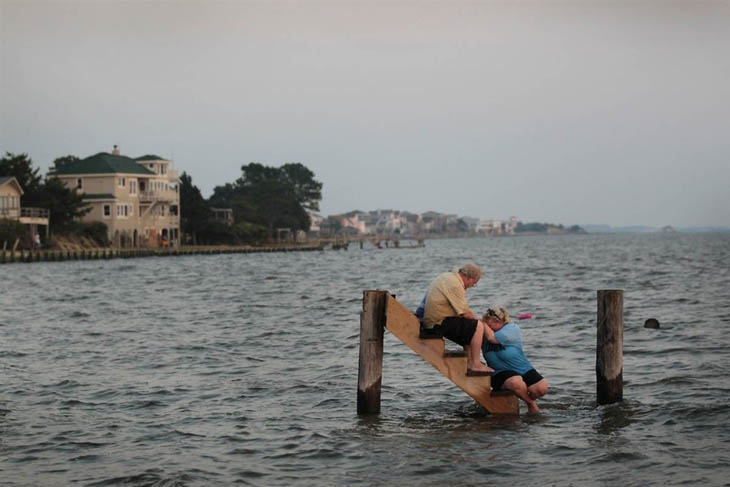 Billy Stinson comforts his daughter on the steps where their cottage once stood before it was destroyed by Hurricane Irene