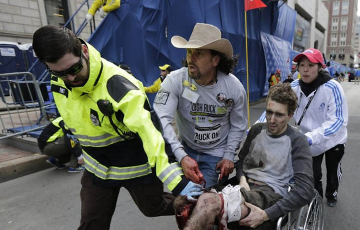 Carlos Arredondo helps Jeff Bauman after the Boston Marathon bombings. The two are now best friends. [2013]