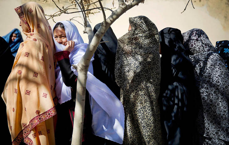 Afghan women turn out to vote in the first democratic transfer of power the country has ever seen. [2014]