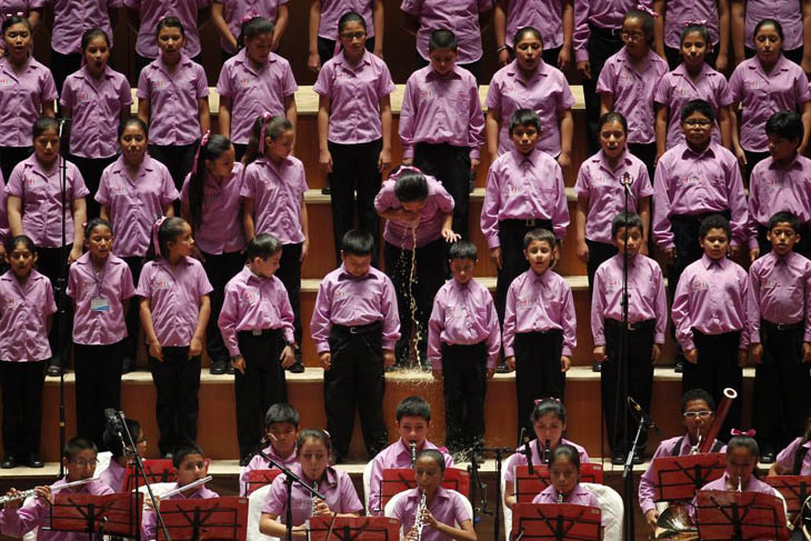 A young member of the choir vomits before performing