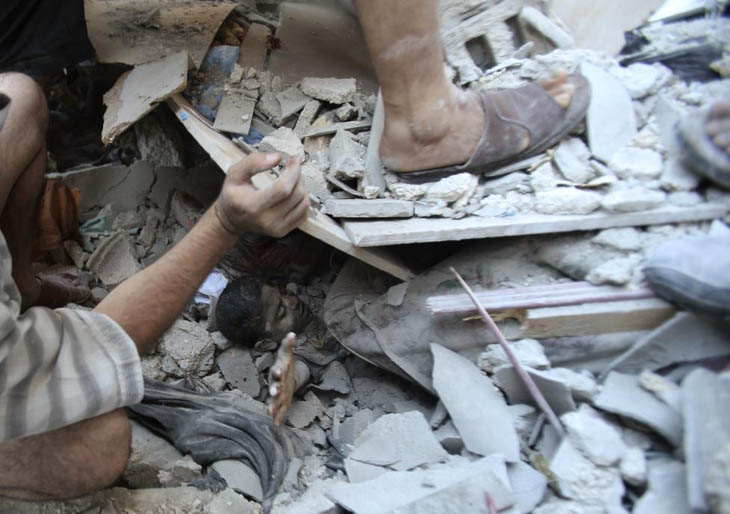 Palestinians rescue Mahmoud al-Ghol from under the rubble of a house in Rafah in the southern Gaza Strip.