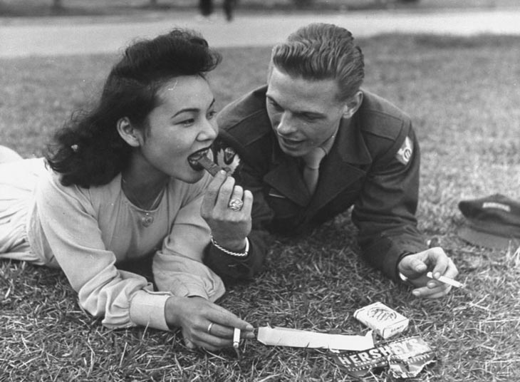 Us Soldier And Local Girl Sharing A Chocolate Bar And Cigarettes, 1940s